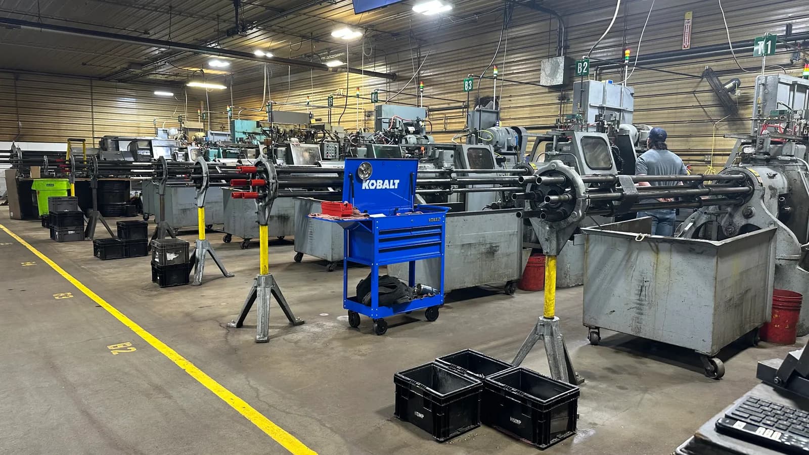 Precision machine shop floor with manual lathes and tooling