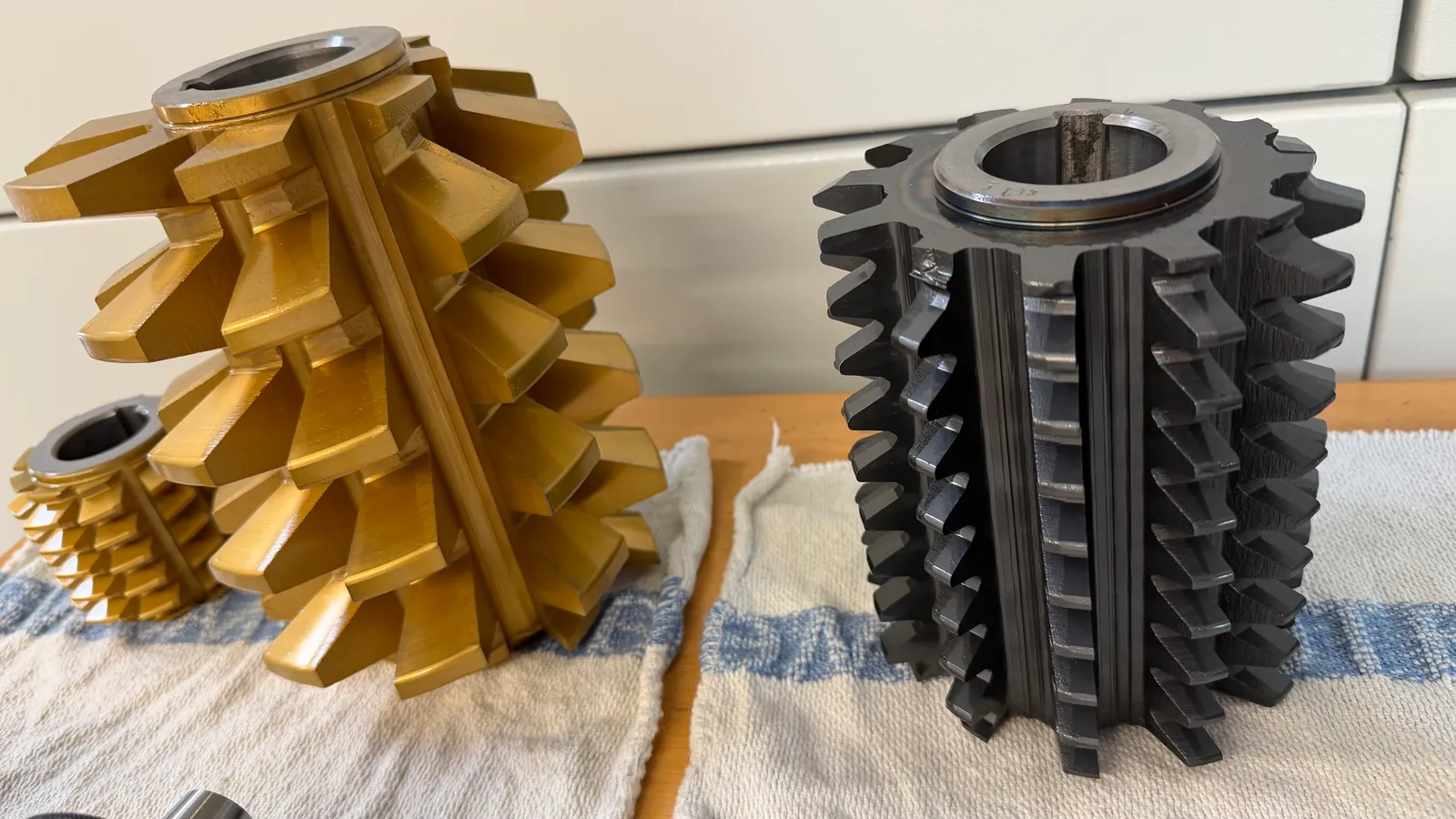 Rows of gear hob cutters staged for a hobbing job