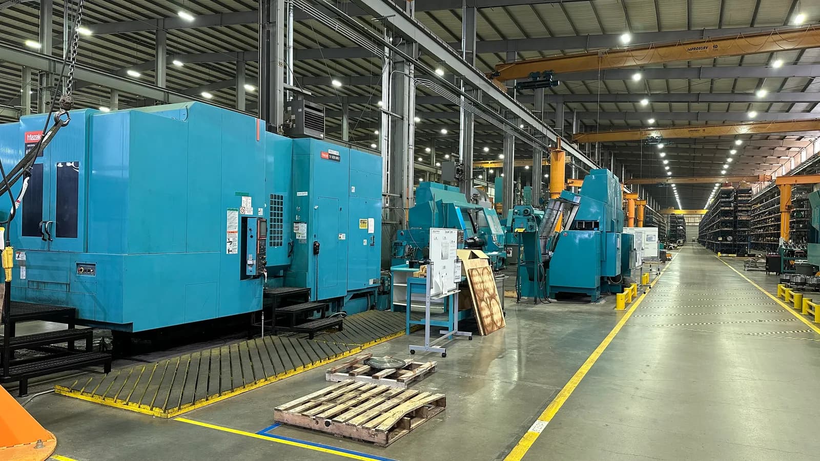 Rows of large CNC machining centers across the production floor
